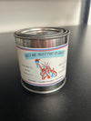 A candle tin with a label that reads 'Hate Will Never Make Us Great' along with an illustration of a fist and the American flag.