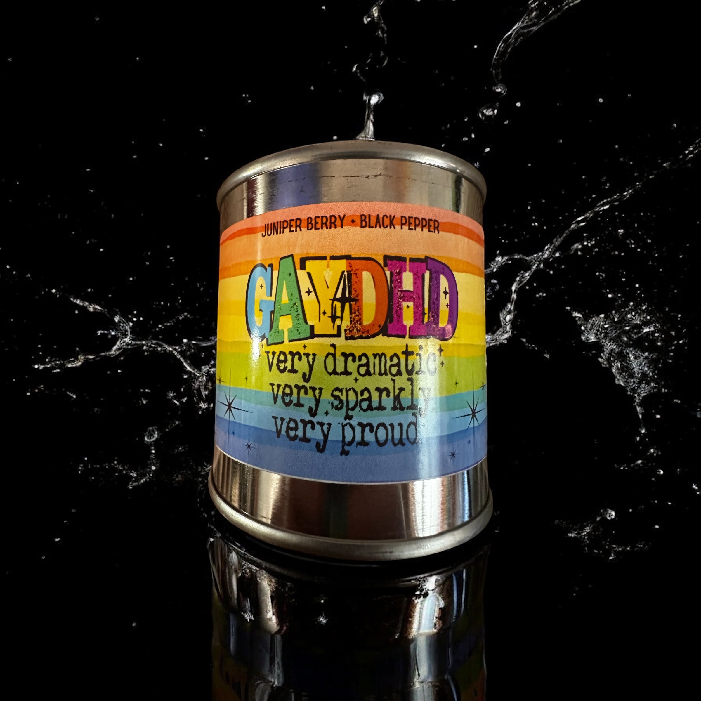 Colorful paint can candle with a rainbow label on a black background