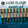Row of Luxe Elixir perfume bottles with water in the background