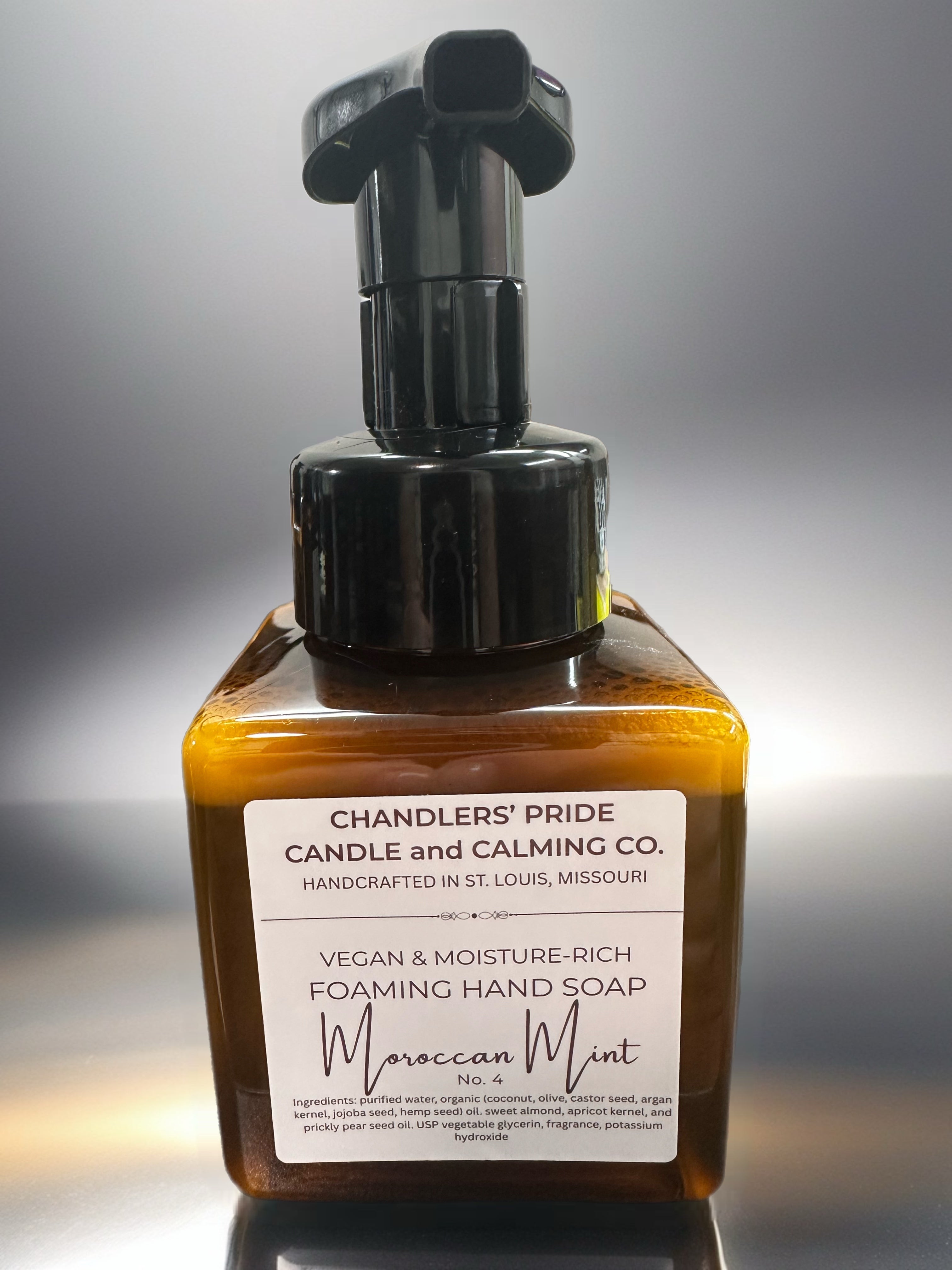 Brown bottle of Chandlers' Pride Moisture-Rich Foaming Hand Soap with a pump on a gray background