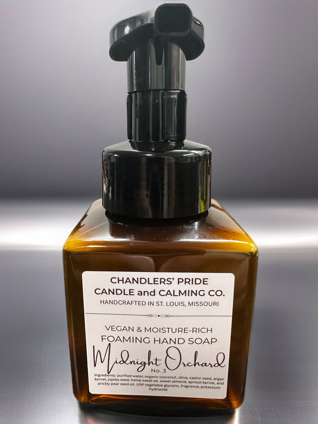 Brown bottle of Chandlers' Pride Vegan & Moisture-Rich Foaming Hand Soap on a gray background