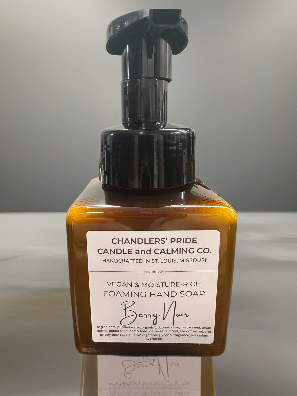 Moisture-rich foaming hand soap bottle with pump and label on a gray background