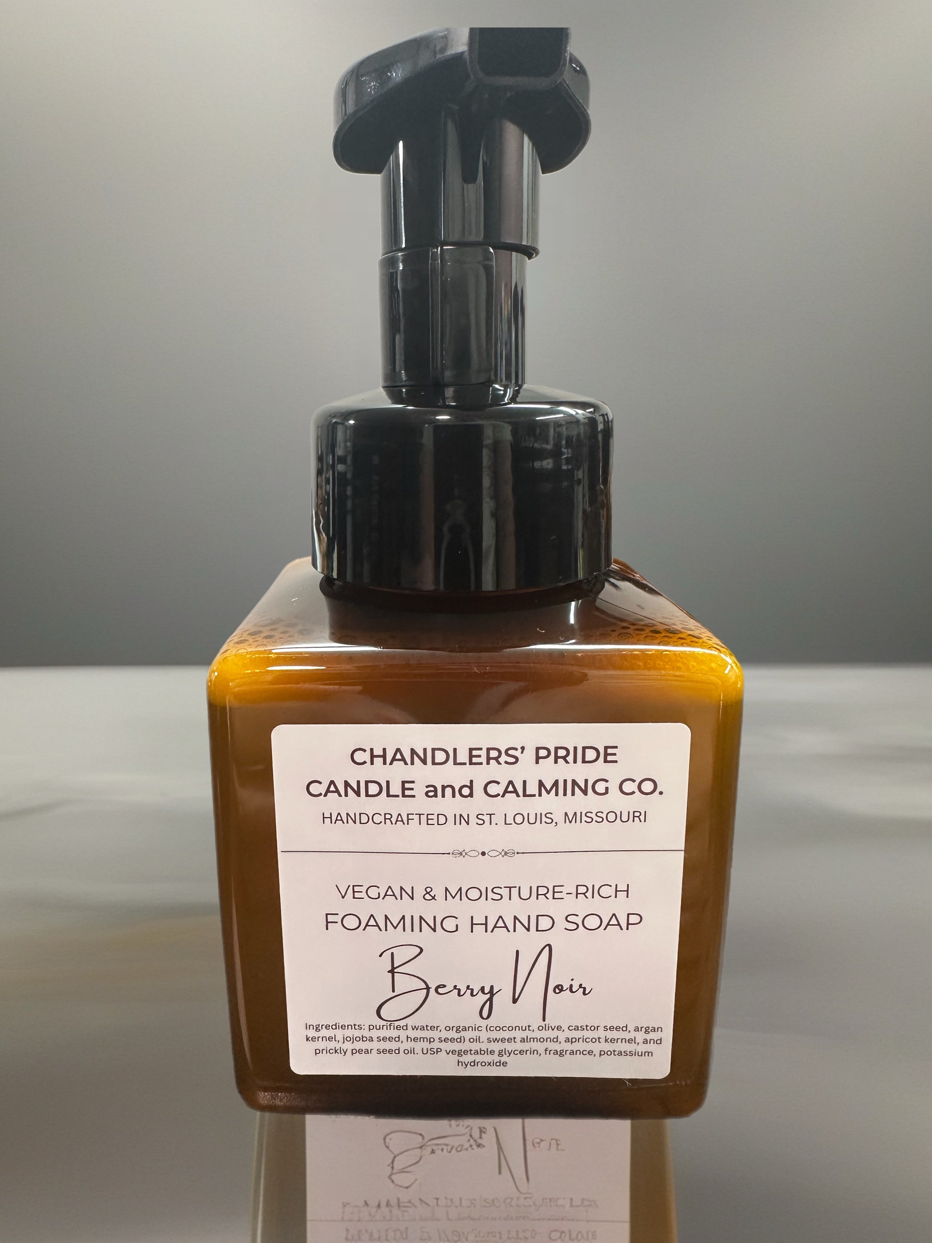 Moisture-rich foaming hand soap bottle with pump and label on a gray background
