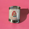 Candle in a paint can with a graphic of a drag queen and text on a pink background