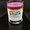 Candle with a rainbow-themed label on a black background